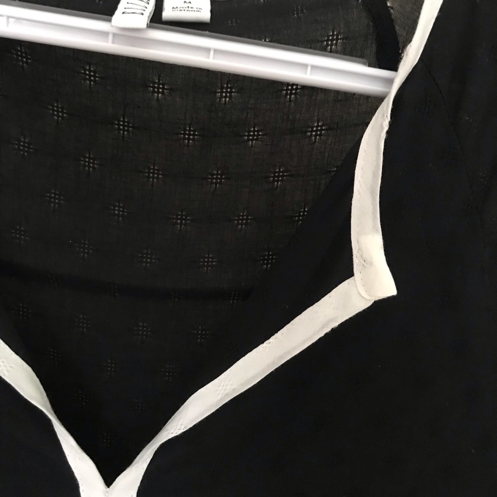 Barely sheer black flowing blouse.